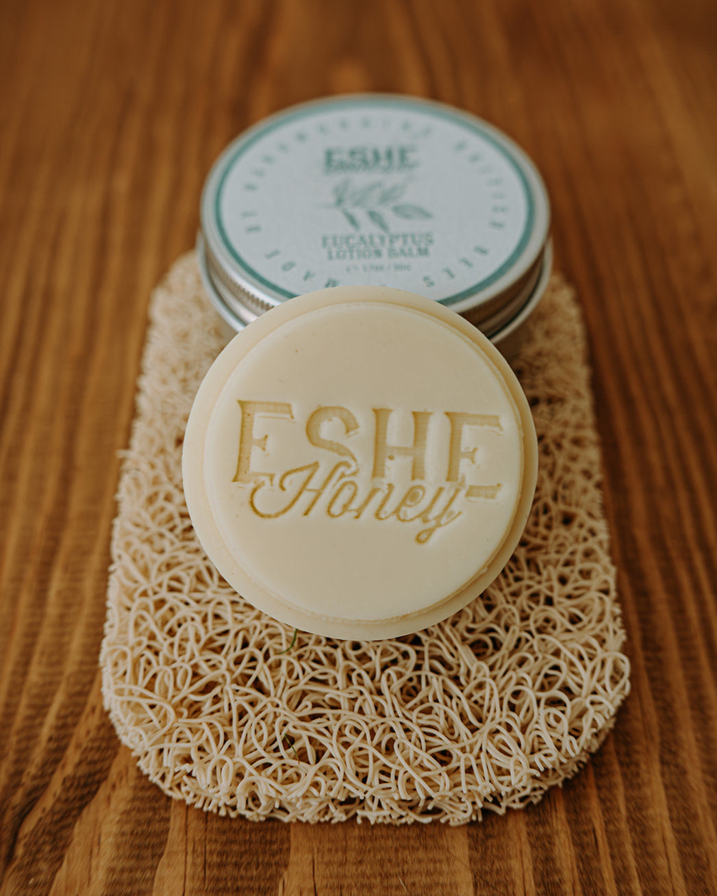 Bar of Eshe Eucalyptus Lotion Balm on a wooden surface