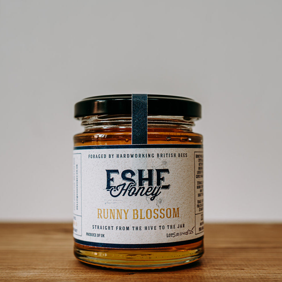 Jar of Eshe Honey Bunny Blossom on a wooden surface with a white background