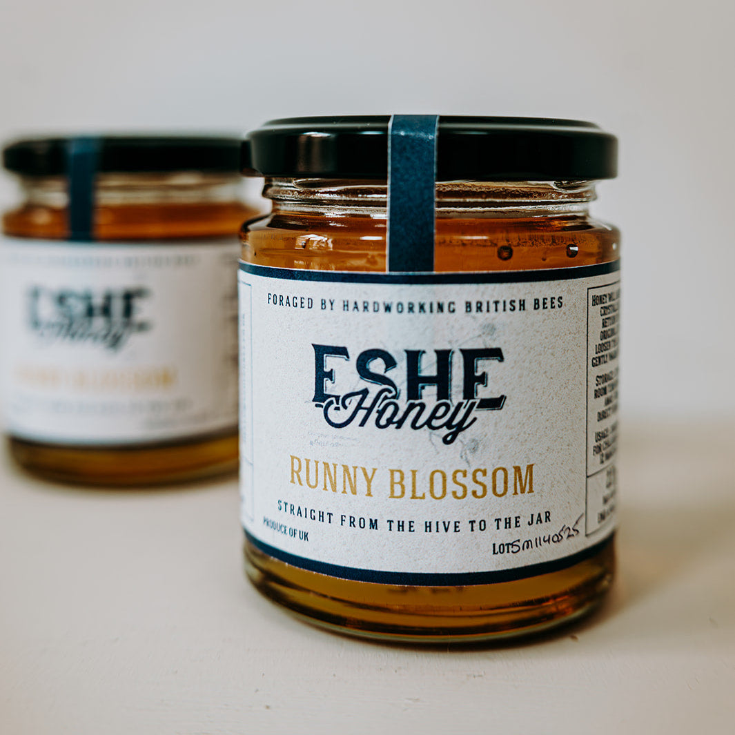 Two jars of Eshe Honey with labels on a white background