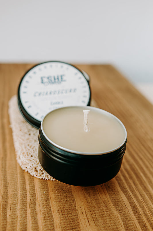 Black candle jar on a wooden surface