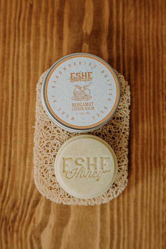 ESHE skincare bergamot lotion balm on a wooden surface
