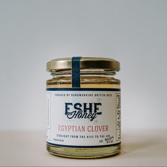 Jar of Eshe Honey Egyptian Clover on a neutral background