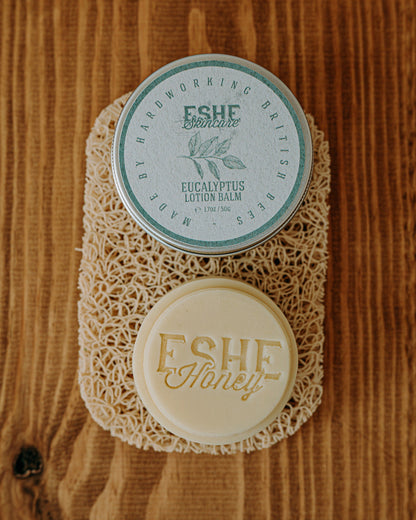 Eucalyptus lotion balm with 'ESHE Honey' branding on a wooden surface